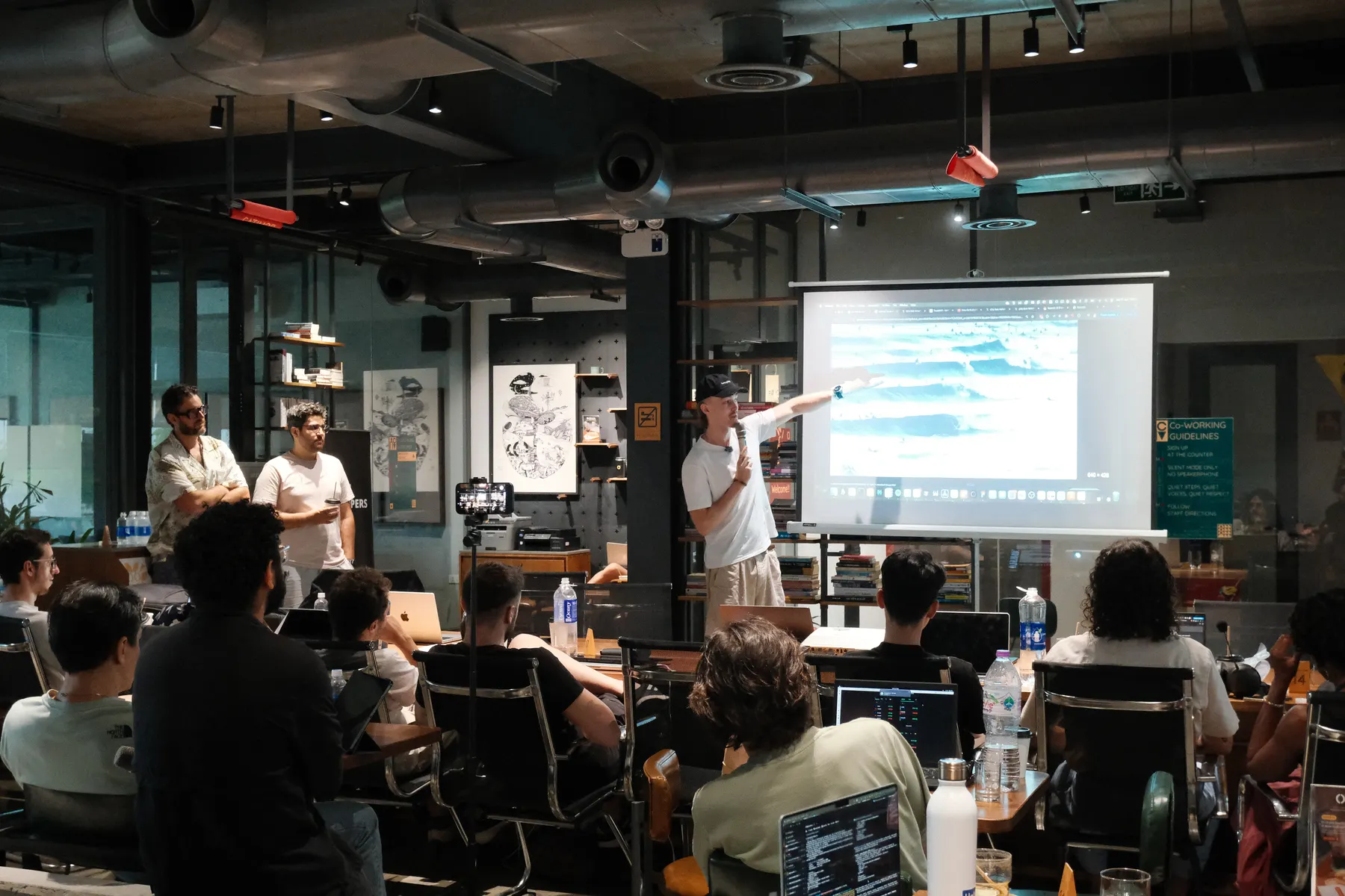 Founder demoing a product on screen at Frontier Club AI Meetup #2 in Da Nang